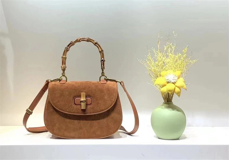 Curated women's handbag displayed beside a decorative vase, highlighting a stylish and versatile fashion accessory.
